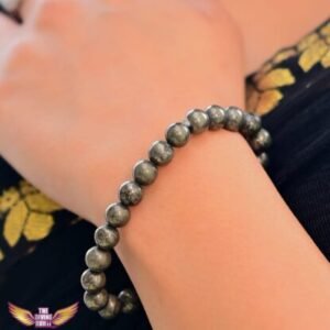 Close-up of a Pyrite crystal bracelet on a woman's wrist, symbolizing abundance, protection, and confidence.