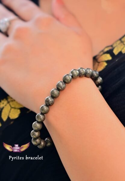 Close-up of a Pyrite crystal bracelet on a woman's wrist, symbolizing abundance, protection, and confidence.