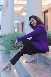 Ruhi Rai – Professional Numerologist in Bhopal sitting confidently in a formal purple blazer