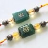 Handcrafted numerology healing rakhis with engraved codes and crystals by Ruhii Rai, Bhopal.